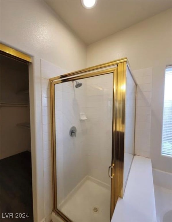 bathroom featuring a wealth of natural light and walk in shower