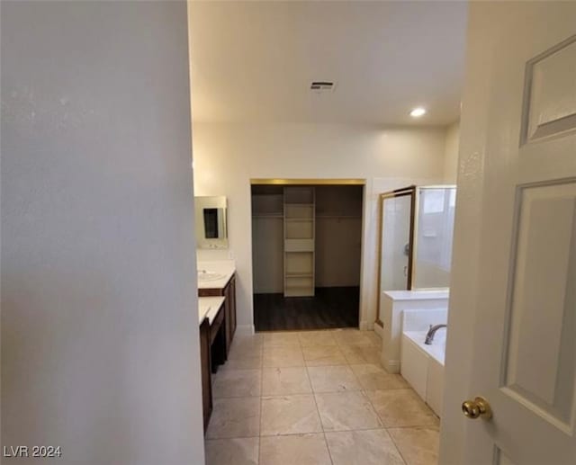 bathroom with vanity, independent shower and bath, and tile patterned floors