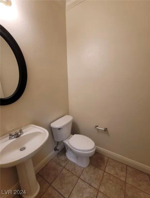 bathroom featuring tile patterned flooring, toilet, and sink