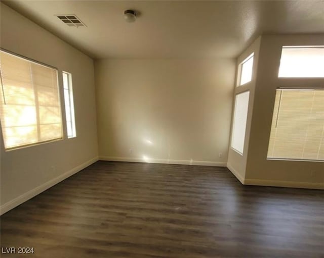 empty room with dark hardwood / wood-style floors