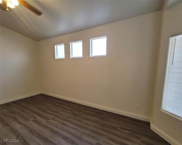 empty room with dark wood-type flooring and ceiling fan