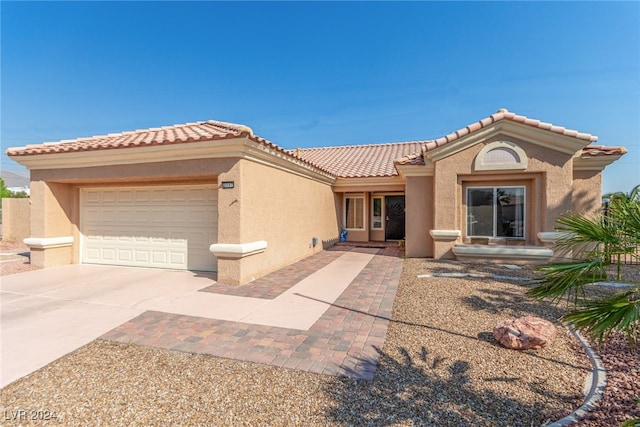 mediterranean / spanish-style home featuring a garage