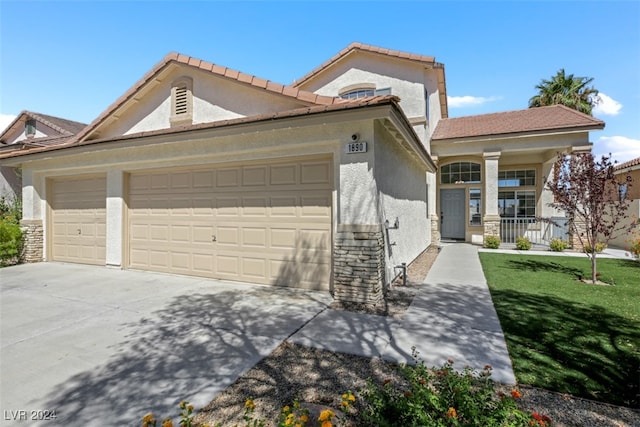 view of front of home featuring a garage, a front yard, and a porch