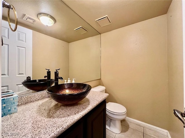 bathroom featuring vanity, toilet, and tile patterned flooring