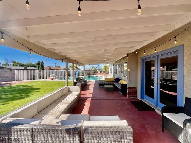 view of patio featuring a fenced in pool, an outdoor living space, and french doors