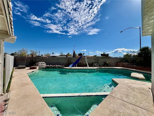 view of pool with a water slide