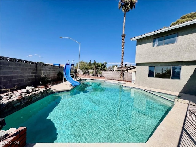 view of swimming pool featuring a water slide