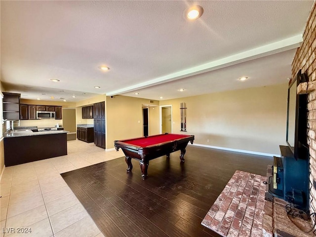 playroom with billiards, sink, a textured ceiling, and light tile patterned floors