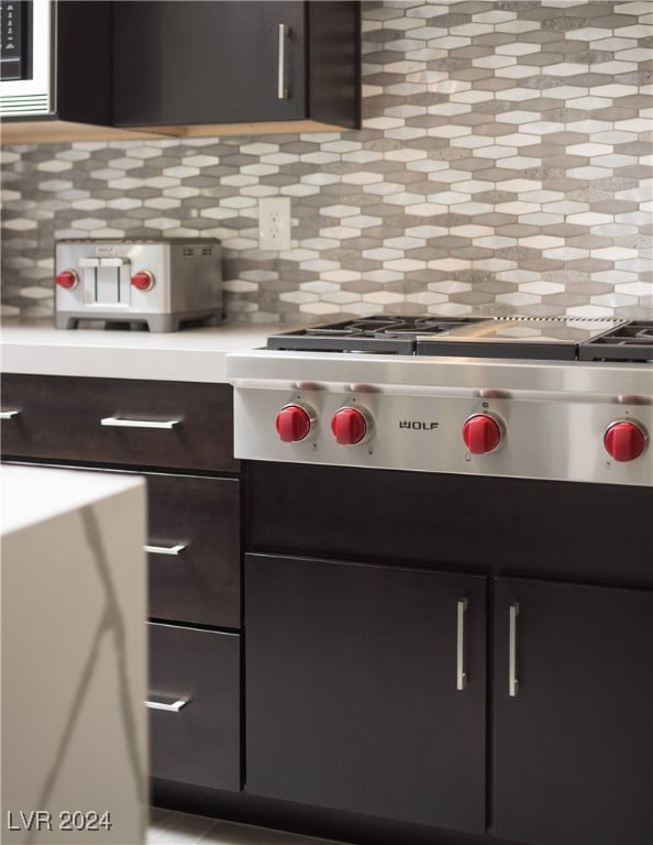 kitchen featuring stainless steel gas cooktop, dark brown cabinetry, and tasteful backsplash