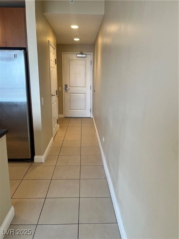 hall featuring light tile patterned floors