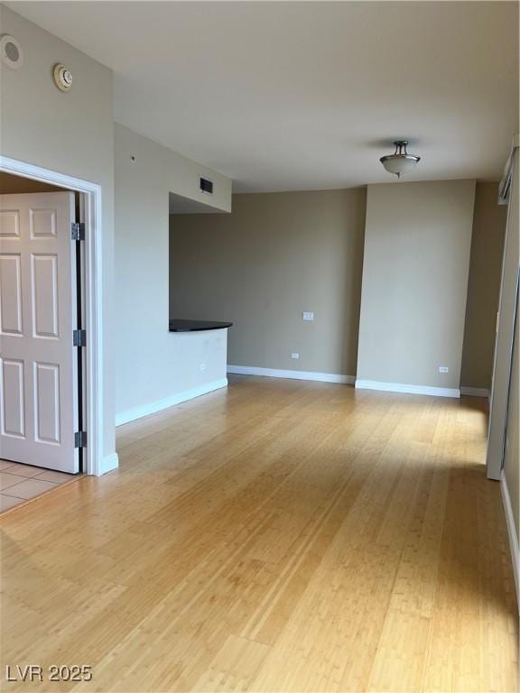 spare room featuring light wood-type flooring