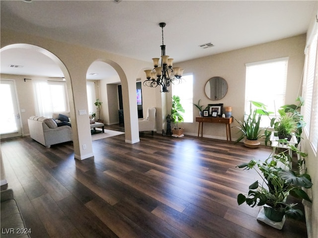 dining room featuring an inviting chandelier and dark hardwood / wood-style floors