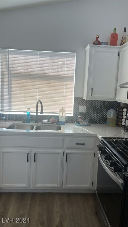 kitchen featuring white cabinets, backsplash, plenty of natural light, and sink