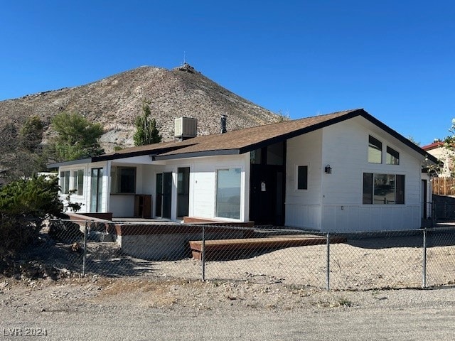 view of front facade featuring central AC unit and a deck with mountain view