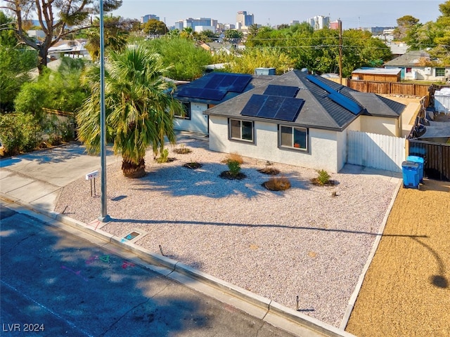 view of front facade featuring solar panels