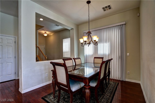 dining area featuring dark hardwood / wood-style floors and a notable chandelier