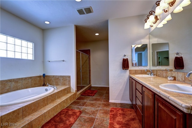 bathroom with tile patterned floors, shower with separate bathtub, and vanity