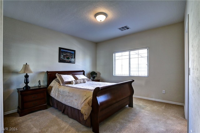 bedroom featuring carpet and a textured ceiling