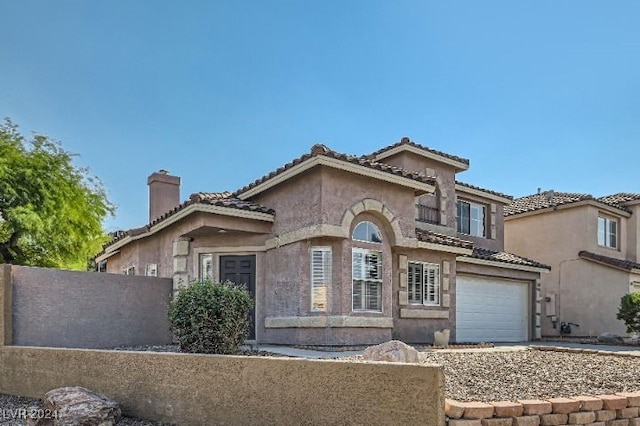 mediterranean / spanish home with a garage