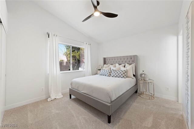 bedroom with light carpet, lofted ceiling, and ceiling fan