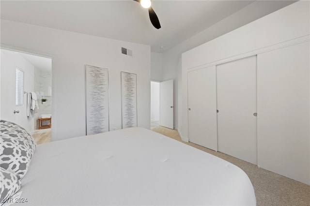 carpeted bedroom with ceiling fan and ensuite bathroom