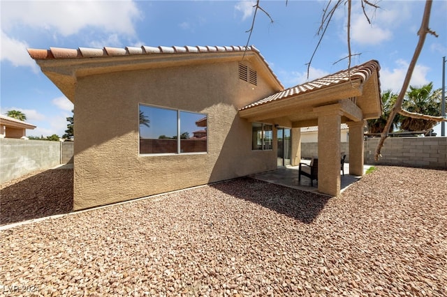 back of property with a patio