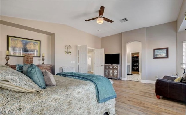 bedroom featuring ceiling fan, light hardwood / wood-style floors, and lofted ceiling