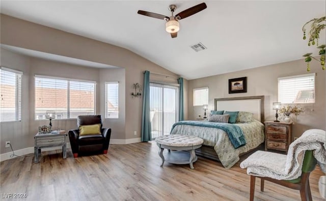 bedroom featuring ceiling fan, light hardwood / wood-style floors, lofted ceiling, and multiple windows