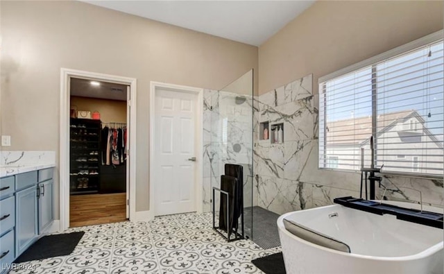 bathroom featuring tile patterned flooring, vanity, and independent shower and bath