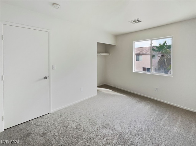 unfurnished bedroom featuring a closet and carpet