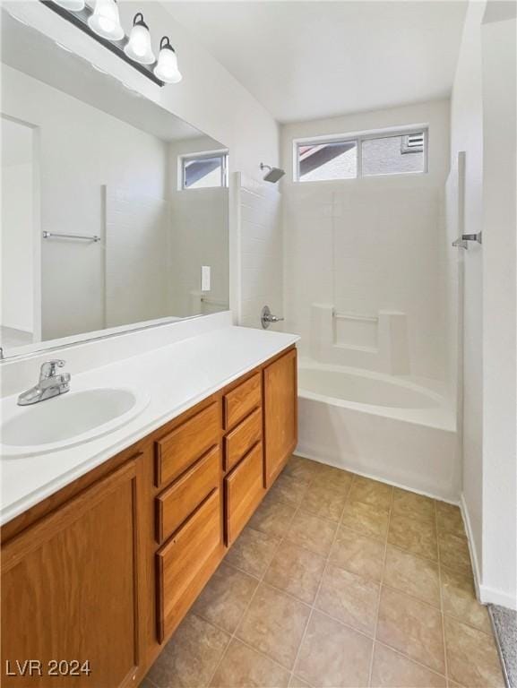 full bathroom featuring a wealth of natural light, tile patterned flooring, vanity, and shower / tub combination