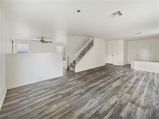 unfurnished living room with dark wood-type flooring and ceiling fan