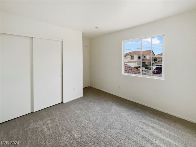 unfurnished bedroom featuring carpet and a closet