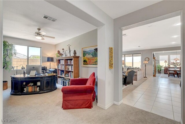 sitting room featuring tile patterned flooring, visible vents, carpet flooring, and a healthy amount of sunlight