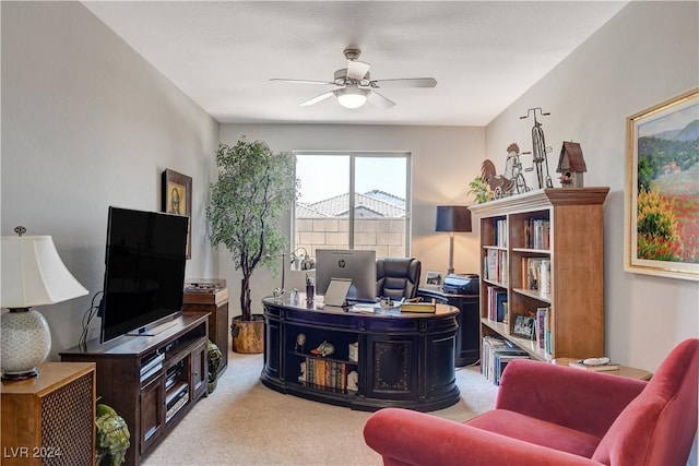 office with a ceiling fan and light colored carpet