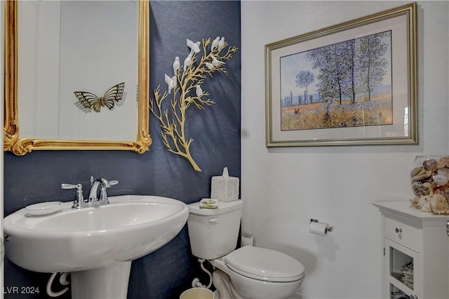 bathroom with toilet and a sink