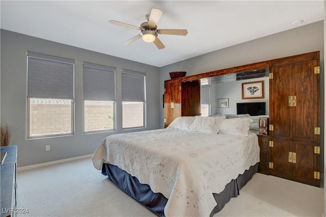 carpeted bedroom with baseboards and ceiling fan