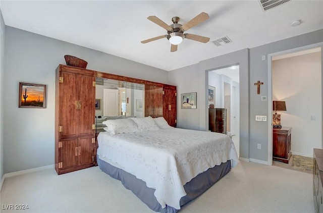 bedroom featuring visible vents, light carpet, baseboards, and a ceiling fan