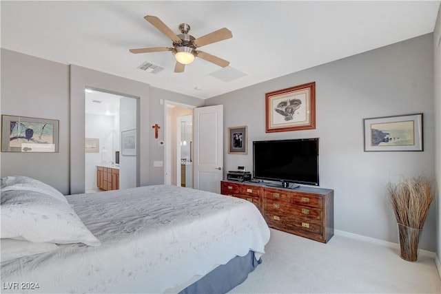 carpeted bedroom with ensuite bath, baseboards, visible vents, and ceiling fan