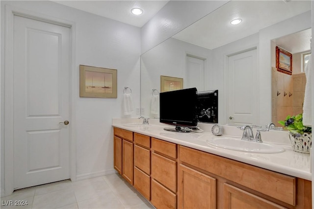 full bath with a sink, recessed lighting, double vanity, and tile patterned flooring