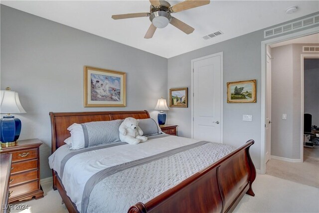 bedroom featuring visible vents, light colored carpet, and ceiling fan