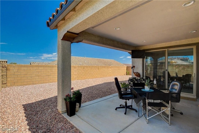 view of patio featuring outdoor dining area and a fenced backyard