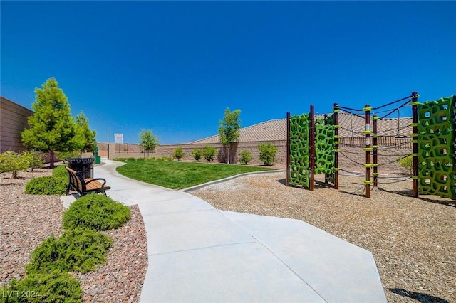 view of property's community with fence and playground community