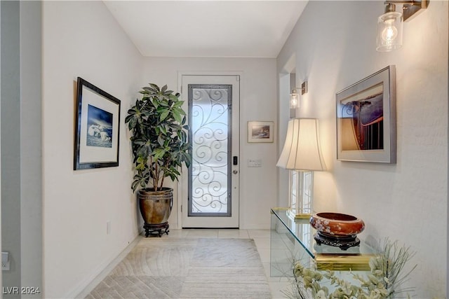 entryway with tile patterned flooring and baseboards