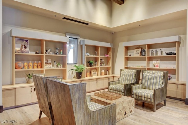 living area featuring visible vents and light wood finished floors