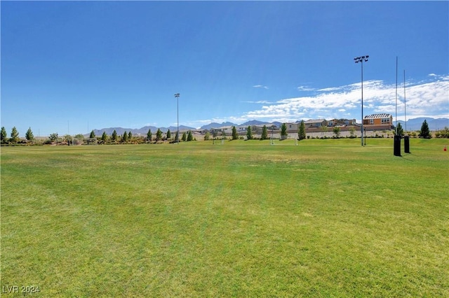 view of community featuring a lawn and a mountain view