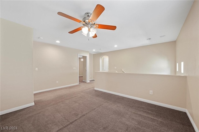 carpeted spare room featuring ceiling fan