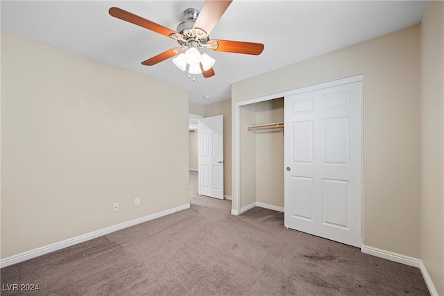 unfurnished bedroom featuring carpet, ceiling fan, and a closet