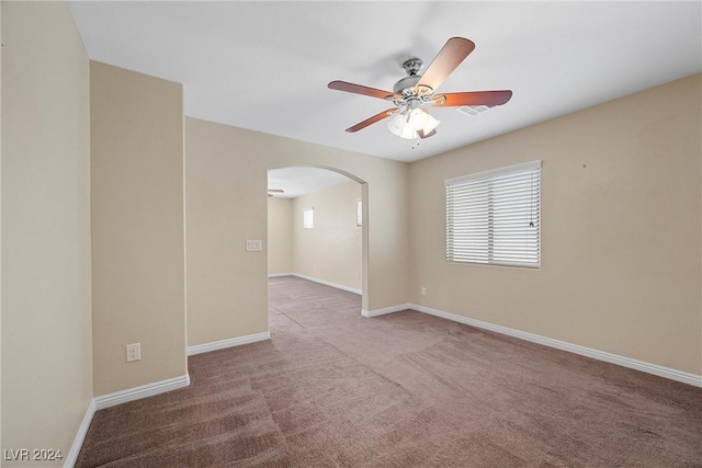 carpeted spare room with ceiling fan