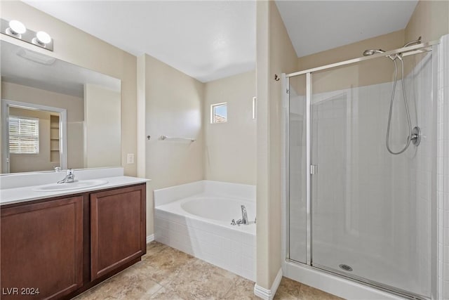 bathroom with plus walk in shower, vanity, and tile patterned flooring